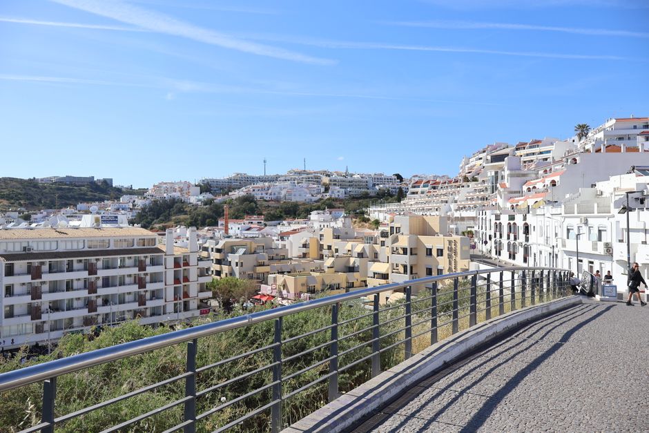 Panoramic view of Albufeira, Portugal, showcasing white Mediterranean-style buildings under a clear blue sky.