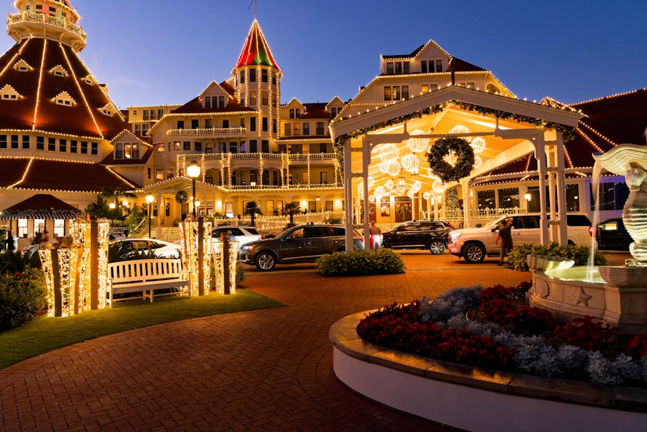 Stunning evening photo of a beautifully lit hotel with festive decorations and vibrant lights.