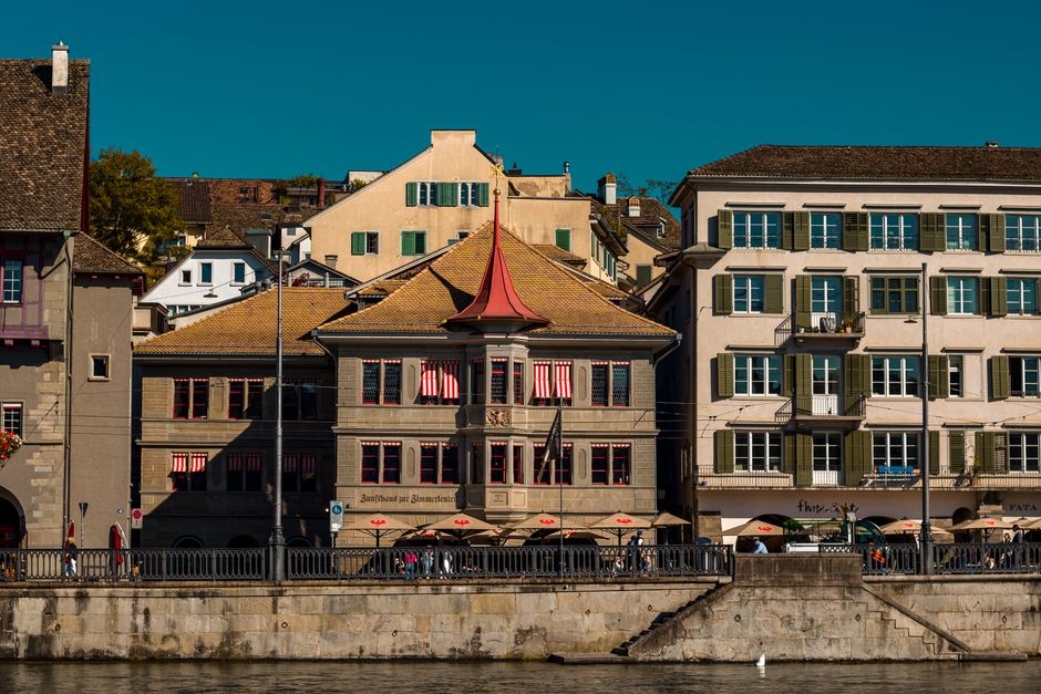Charming waterfront view showcasing historic architecture in Zurich's old town.
