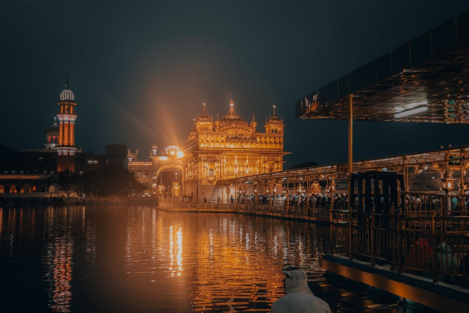 Night view of the Golden Temple reflecting in the water, Amritsar, India.