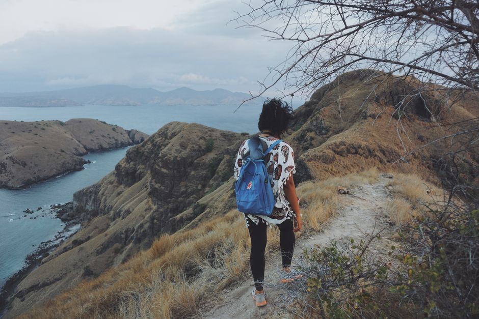 A woman hiking in the scenic landscapes of East Nusa Tenggara, Indonesia.