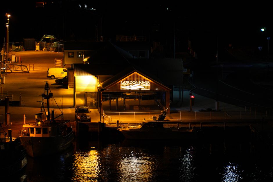 Illuminated Gordon River Cruise terminal at night in Strahan, Tasmania.