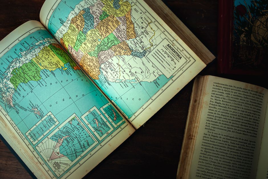 Explore an antique map of Argentina and vintage books on a wooden table.
