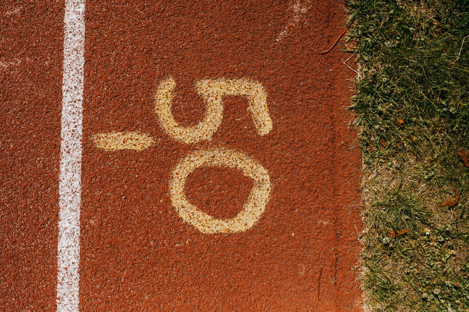 Close-up view of the number 50 on a track, symbolizing athletic distance marking.
