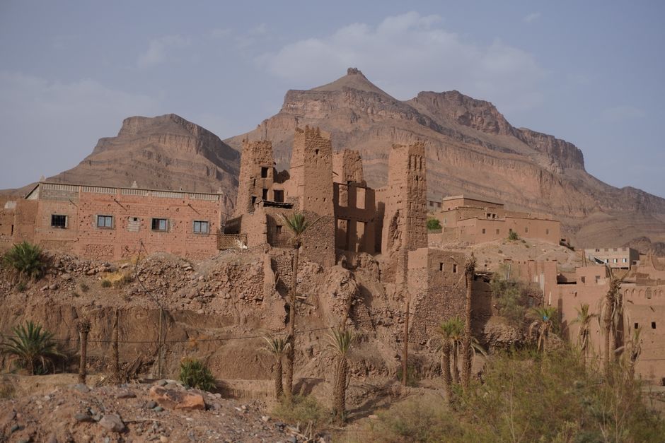 Historic mudbrick buildings in Agdz, Morocco with mountain backdrop. Perfect for travel and cultural exploration themes.