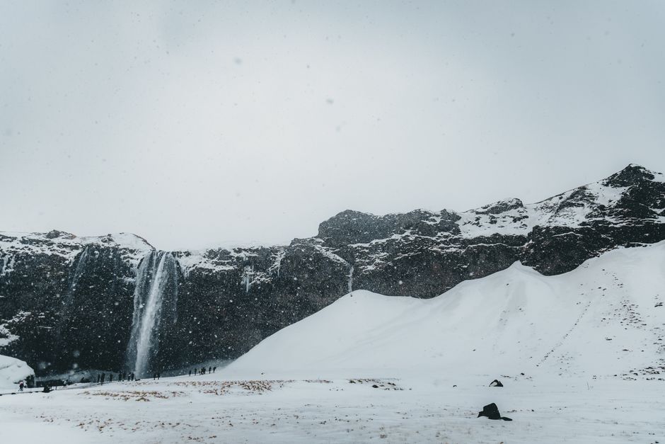 Picturesque view of rocky terrain covered with snow against cloudless sky during winter time in cold day in nature outside