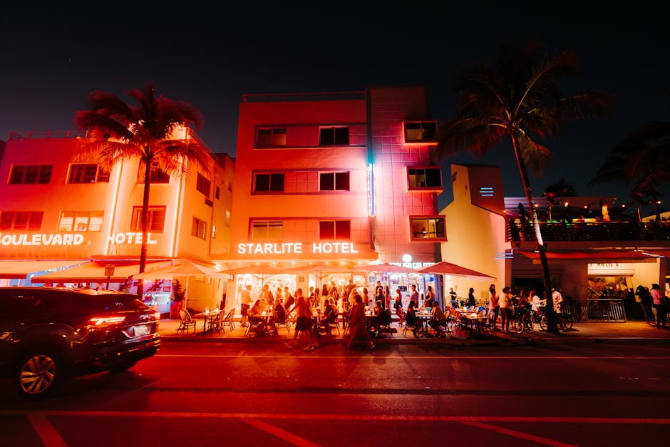 Street view of lively nightlife at the illuminated Starlite Hotel in an urban setting.