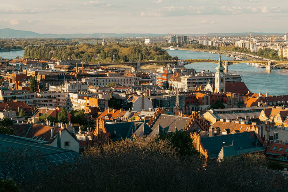 Stunning aerial view of Budapest with the Danube River and historic architecture under a clear sky.