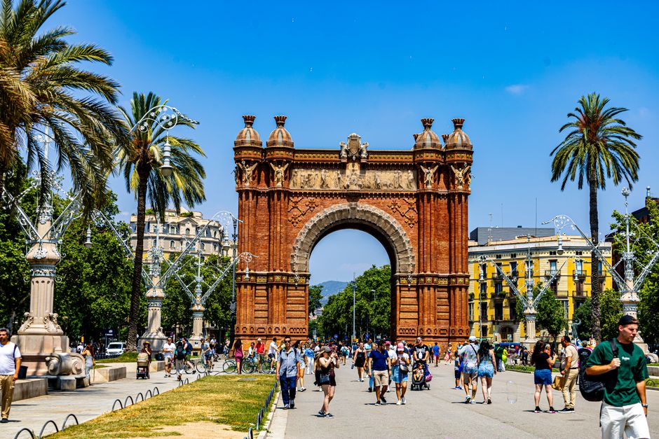 A bustling scene at Arc de Triomf, Barcelona, showcasing architecture and vibrant street life.