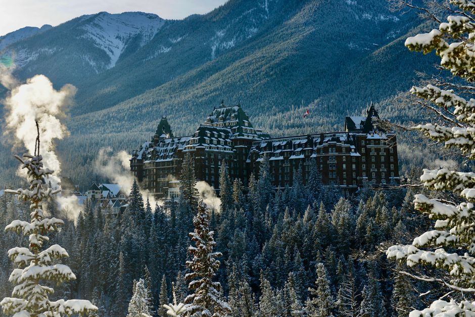 Scenic winter view of the Banff Springs Hotel nestled in the snow-covered Rocky Mountains.