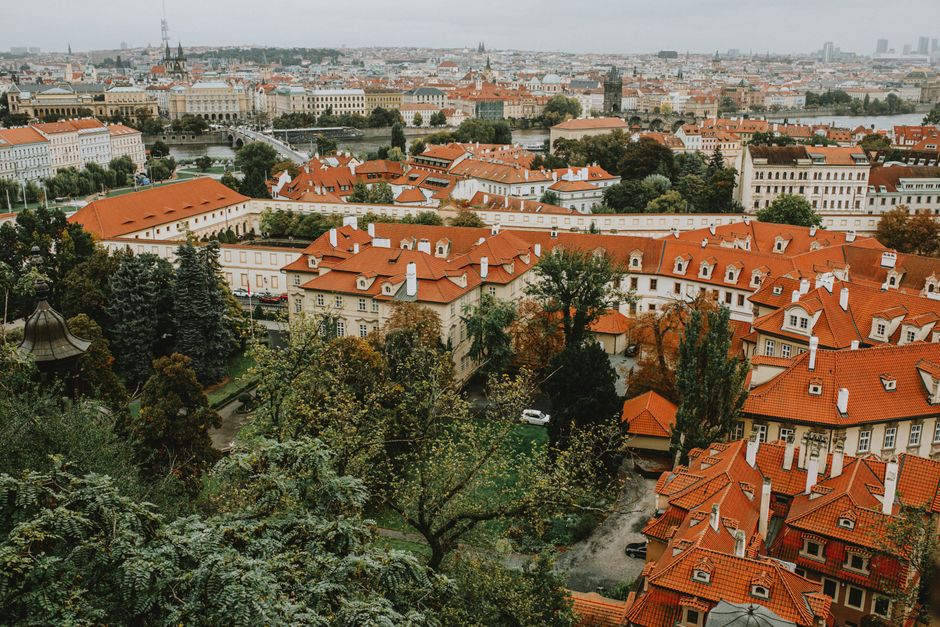 Aerial view of Prague's red rooftops and historic architecture.