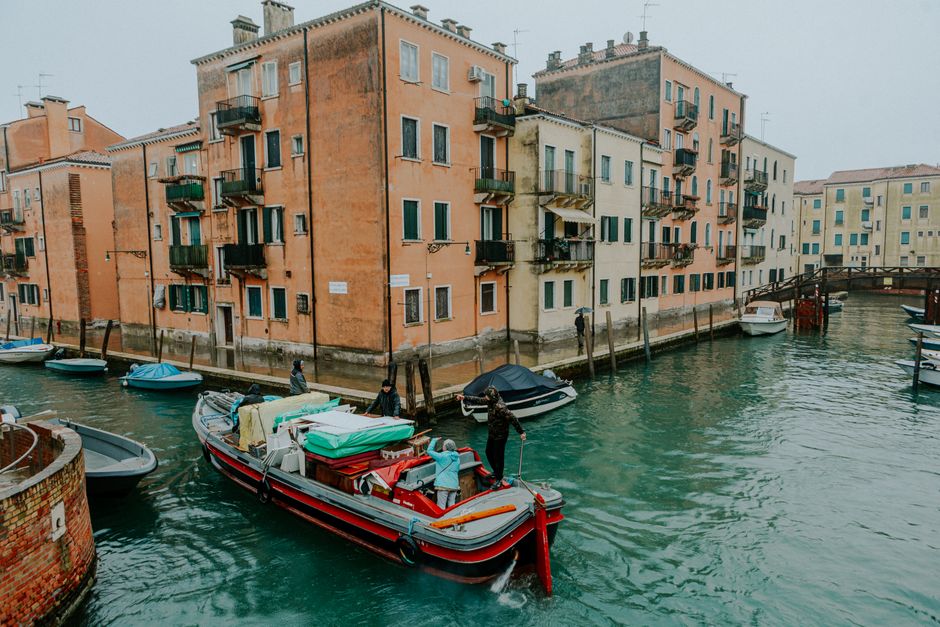 Charming view of Venice's canals featuring colorful historic buildings and small boats, capturing the essence of Italian waterways.