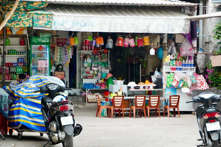 Vibrant street market shop with colorful goods and chairs, perfect for local shopping scenes.