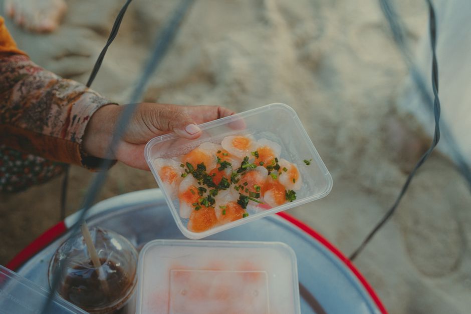 Close-up of traditional Vietnamese rice dumpling cake (Bánh Bột Lọc) at a beach vendor in Phan Thiet, Vietnam.